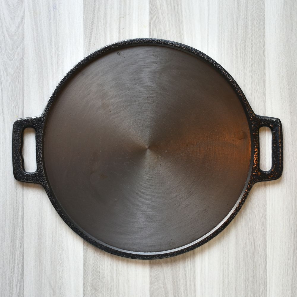 Traditional dosa cooked on cast iron